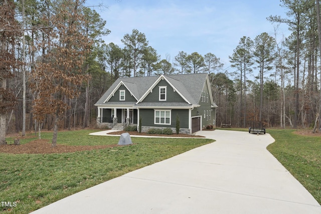 craftsman inspired home featuring concrete driveway, a garage, stone siding, and a front lawn