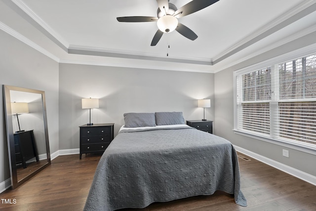 bedroom featuring visible vents, baseboards, dark wood-type flooring, and ornamental molding