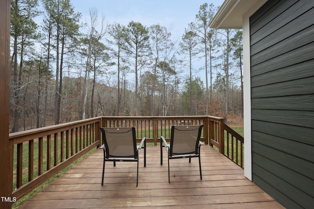 wooden deck with a forest view