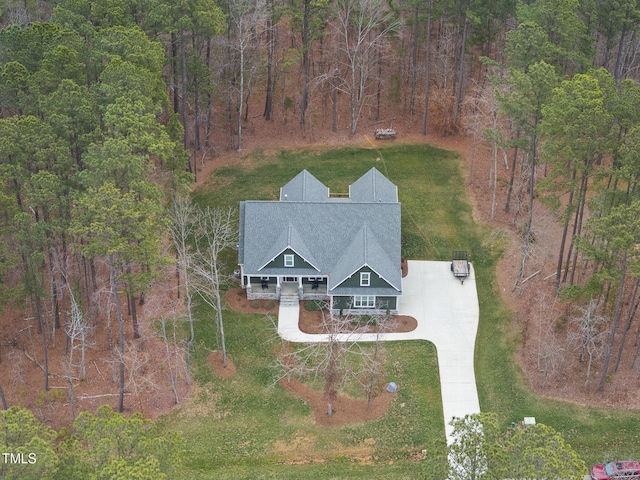 birds eye view of property with a view of trees