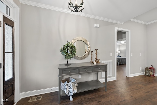 entrance foyer with visible vents, dark wood-type flooring, and ornamental molding