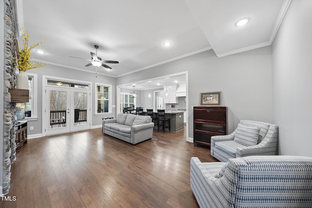 living room with ceiling fan, dark wood finished floors, and ornamental molding