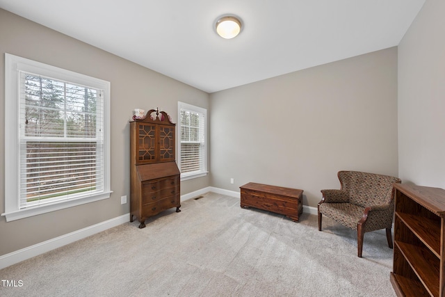 sitting room with light colored carpet and baseboards