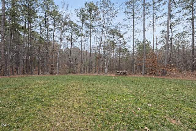 view of yard with a view of trees