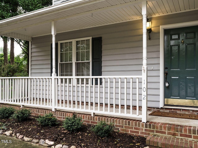 doorway to property featuring covered porch