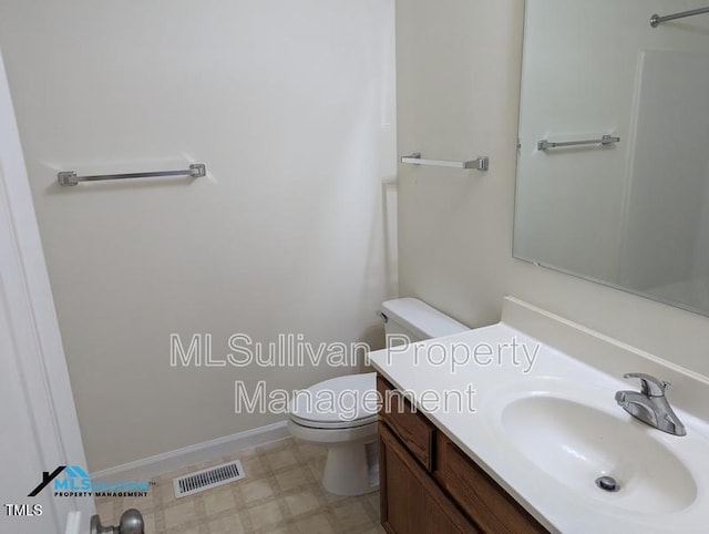 bathroom featuring visible vents, toilet, vanity, baseboards, and tile patterned floors