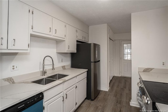 kitchen with stainless steel appliances, dark wood-style flooring, white cabinets, and a sink