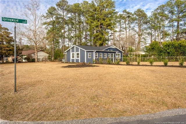 view of front of home featuring fence