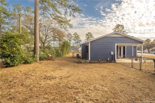 exterior space featuring a carport and fence