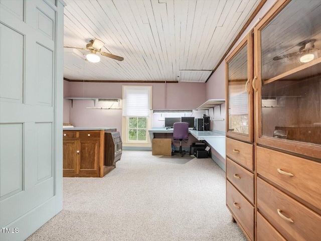 home office with wooden ceiling, light carpet, a ceiling fan, built in study area, and crown molding