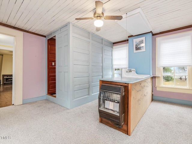 kitchen featuring crown molding, heating unit, light colored carpet, wood ceiling, and ceiling fan