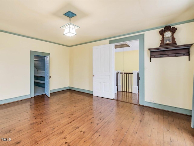 unfurnished room featuring light wood finished floors and baseboards