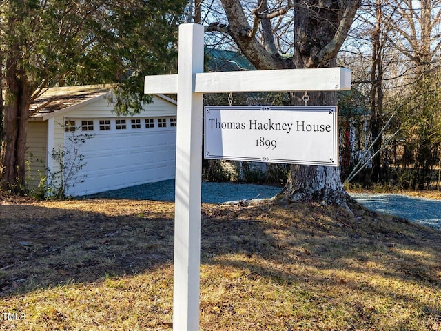 community / neighborhood sign featuring a detached garage