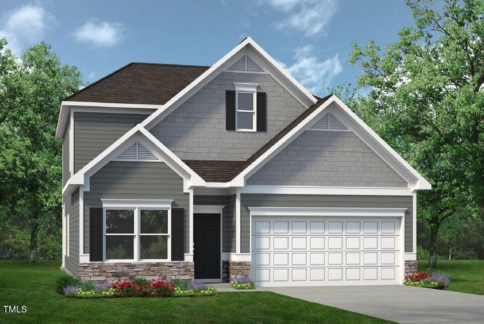 craftsman house with driveway, stone siding, a shingled roof, and a front yard