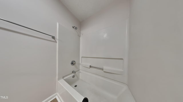 full bath featuring shower / washtub combination and baseboards