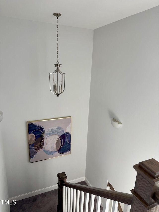 interior details with carpet, baseboards, and a notable chandelier