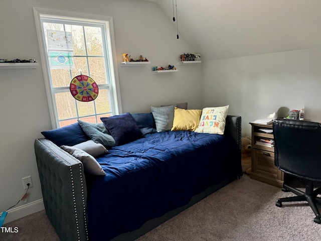 bedroom with carpet floors and vaulted ceiling