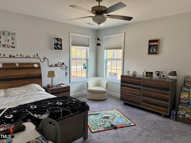 carpeted bedroom with visible vents, ceiling fan, and baseboards