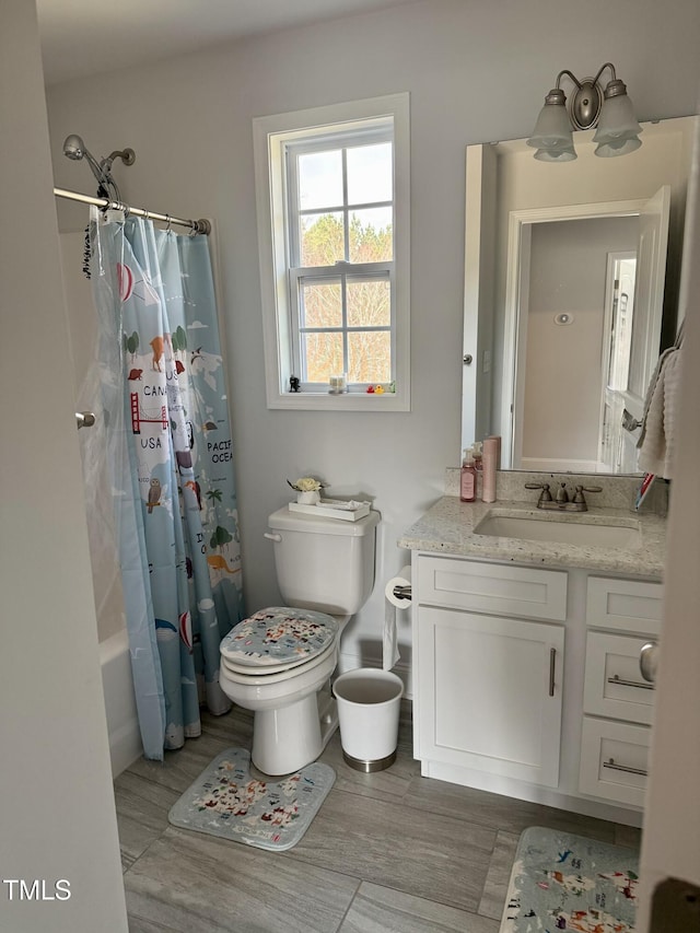 full bathroom featuring shower / tub combo with curtain, vanity, toilet, and wood finished floors