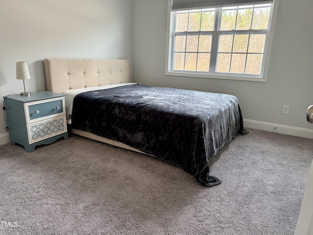 carpeted bedroom with baseboards