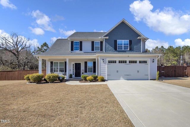 view of front facade with a porch, a garage, fence, driveway, and a front yard