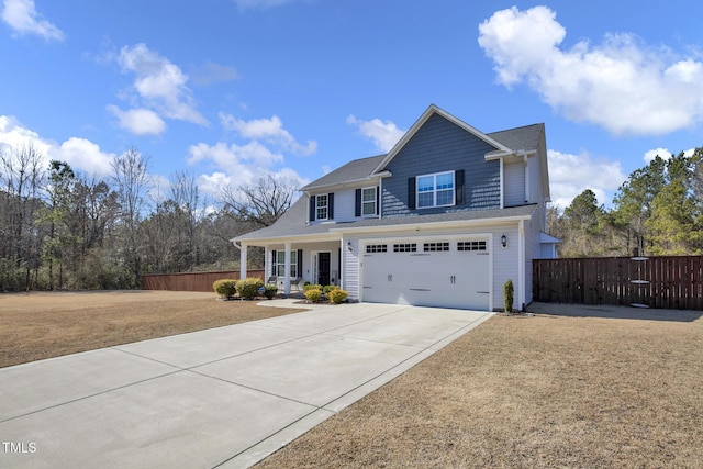 view of front of house with driveway, a porch, an attached garage, and fence