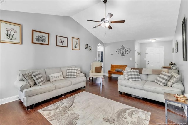 living area with baseboards, ceiling fan, lofted ceiling, wood finished floors, and arched walkways