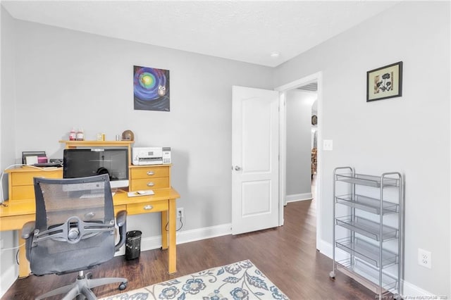 office space with baseboards and wood finished floors