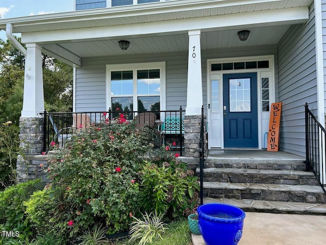 view of exterior entry featuring a porch