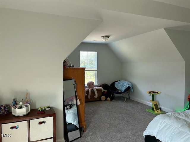 carpeted bedroom with lofted ceiling and baseboards