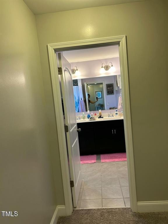 bathroom featuring tile patterned floors, baseboards, and vanity