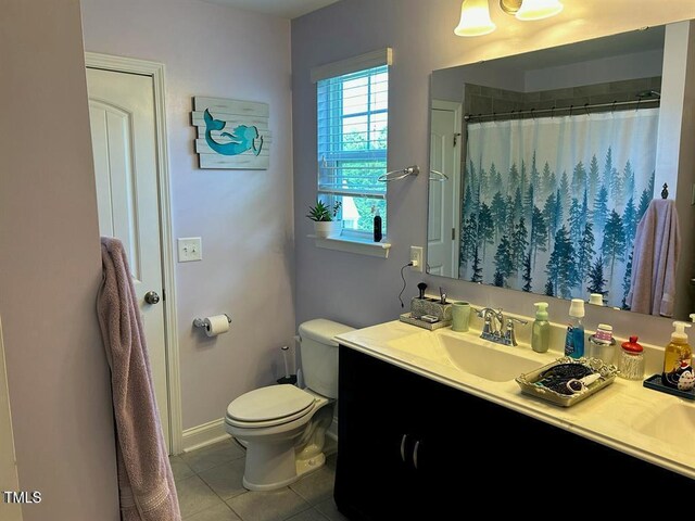 bathroom with tile patterned flooring, curtained shower, vanity, and toilet