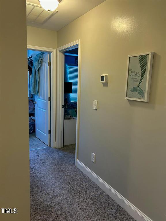 corridor featuring carpet and baseboards