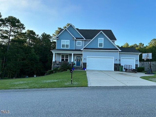 view of front of home featuring driveway, stone siding, an attached garage, a porch, and a front yard