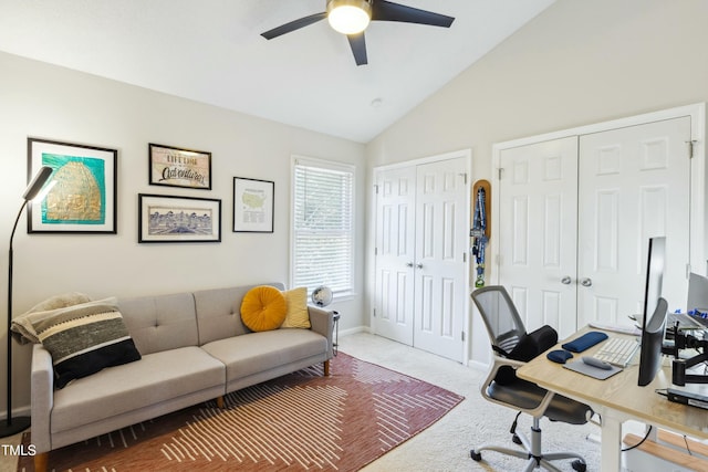 office space with vaulted ceiling, carpet, a ceiling fan, and baseboards