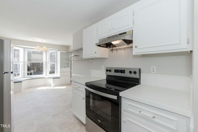 kitchen featuring under cabinet range hood, stainless steel appliances, white cabinets, light countertops, and decorative light fixtures