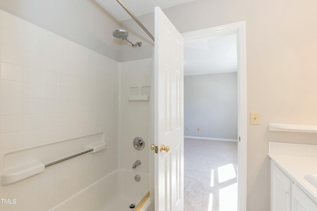 bathroom featuring bathtub / shower combination, vanity, and baseboards