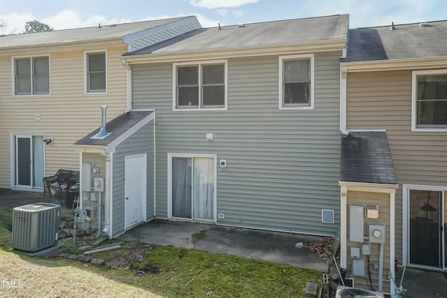 rear view of house featuring a patio area and cooling unit