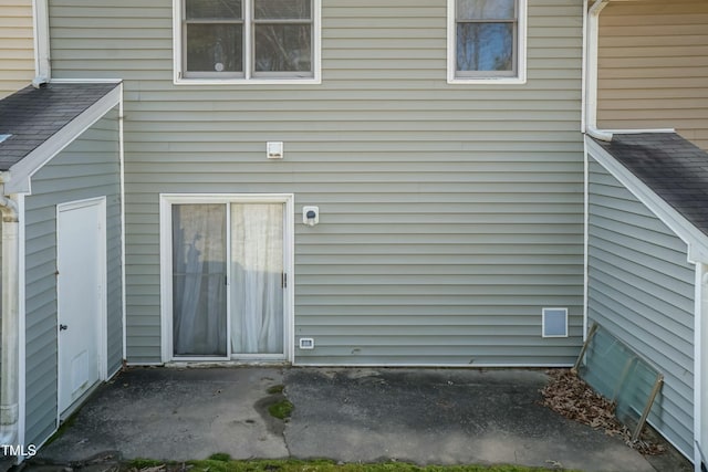 exterior space featuring a shingled roof