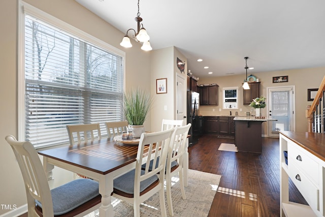 dining room with dark wood-style floors, a notable chandelier, and recessed lighting