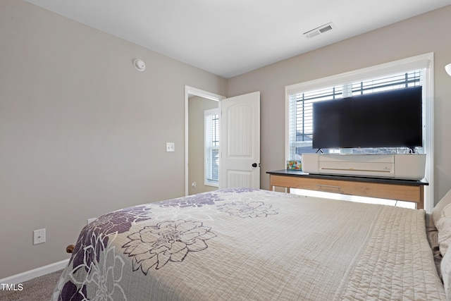 bedroom with baseboards, visible vents, and carpet flooring