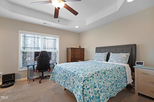 carpeted bedroom with baseboards, visible vents, a raised ceiling, ceiling fan, and recessed lighting