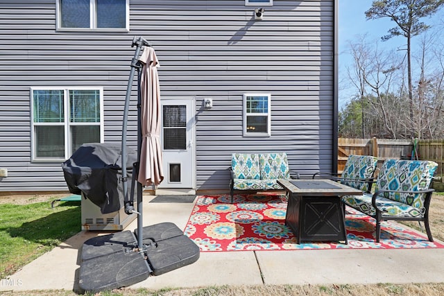 view of patio / terrace featuring an outdoor fire pit, a grill, and fence