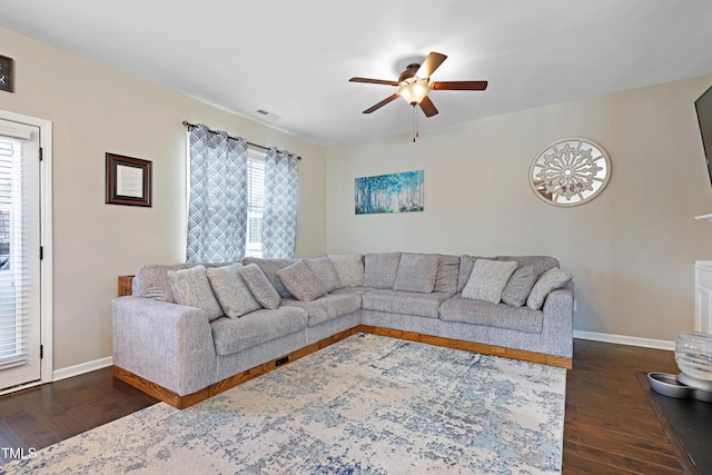 living room featuring baseboards, ceiling fan, visible vents, and hardwood / wood-style floors