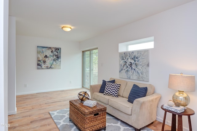 living area featuring wood finished floors and baseboards