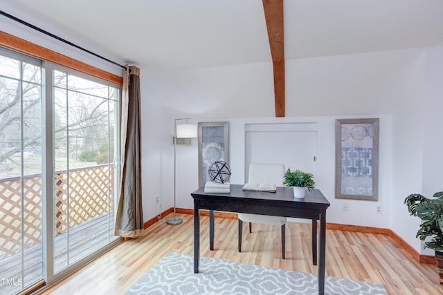 office space featuring beamed ceiling, light wood-type flooring, and baseboards