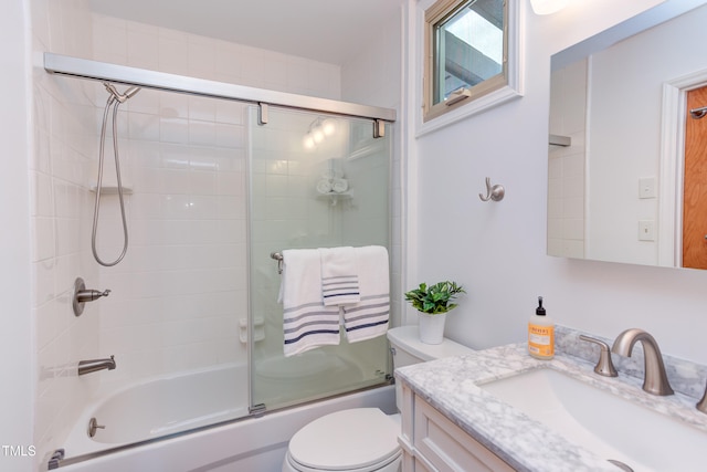 bathroom featuring shower / bath combination with glass door, vanity, and toilet