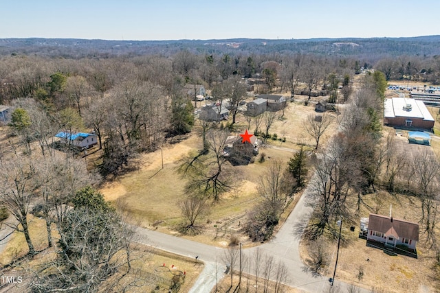 aerial view featuring a forest view and a rural view