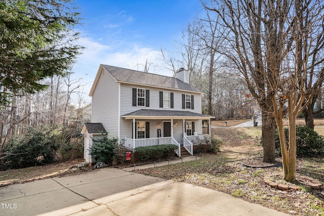 view of front of house featuring roof with shingles, a porch, and a chimney