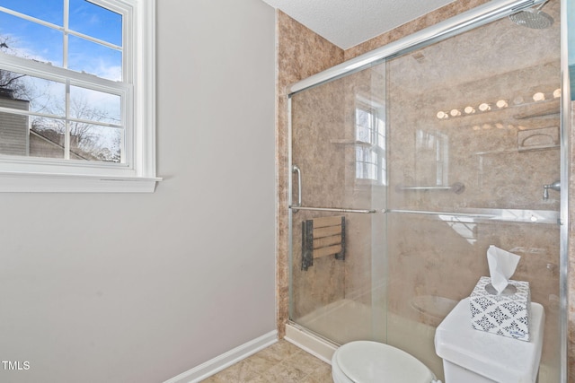 bathroom featuring toilet, a stall shower, tile patterned flooring, and baseboards